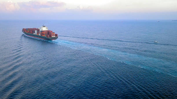 istock Large container ship at sea, loaded with various container brands. ULCV container ship sails on open water fully loaded with containers and cargo. 1253190461