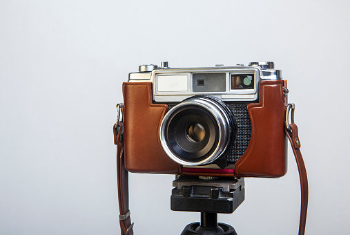 Vintage 1950s 35mm film camera isolated on white background, retro photography equipment