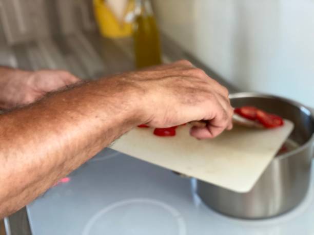 istock close up of mans hands preparing and cooking meal 1253192961