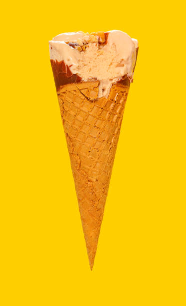 istock side view milk tea flavor ice cream cone with a bite on a yellow background 1253199017