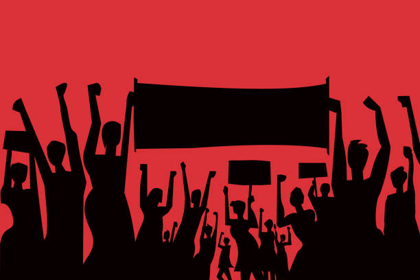 istock Silhouette of cheering demonstrators with placard and banners 1253199120