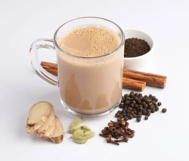 Traditional indian drink - masala tea with spices on  background