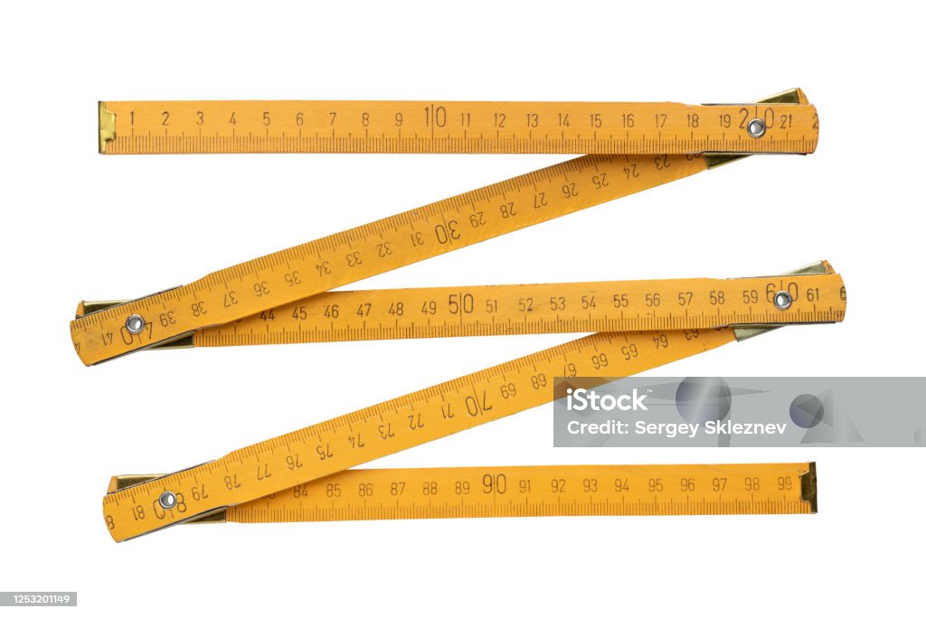 Yellow wooden folding rule Traditional yellow wooden folding rule, isolated on white background Folding Ruler Stock Photo