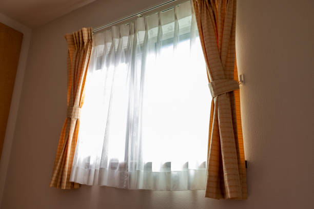 istock Sunlight through the lace curtain into the room 1253204928