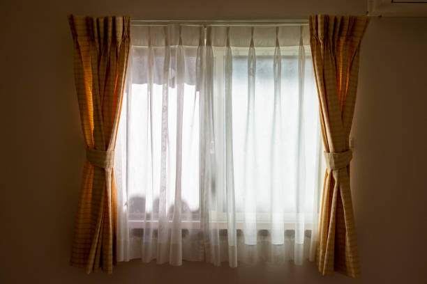 istock Sunlight through the lace curtain into the room 1253204930