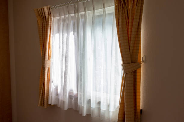 istock Sunlight through the lace curtain into the room 1253204937