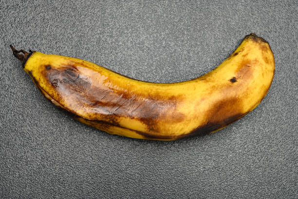 istock overripe banana with a big cracked on dark background 1253204942