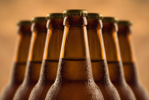 istock Brown full bottle of beer with water drops 1253207404