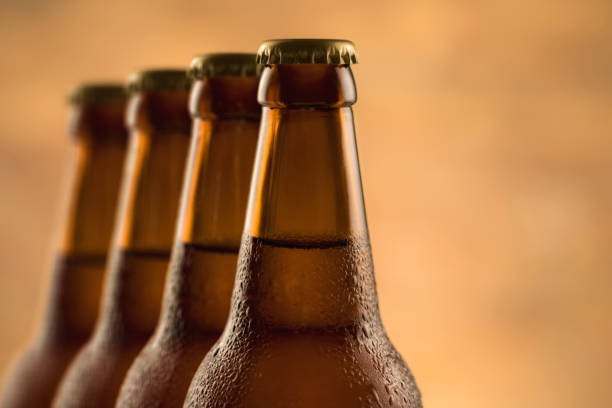istock Brown full bottle of beer with water drops 1253207429