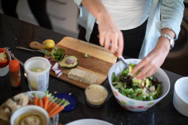 istock Two women having fun in the kitchen while making a healthy meal together for dinner with friends at home. 1253209052
