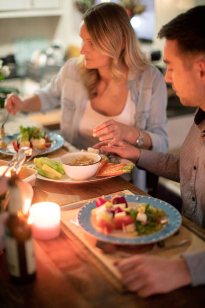 istock Four friends sitting down for a healthy plant-based dinner. 1253209949