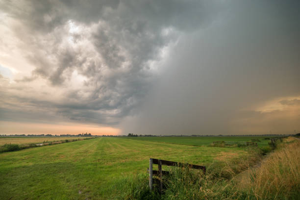 istock View of a thunderstorm over green meadows during sunset 1253210019