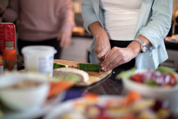 istock Two women having fun in the kitchen while making a healthy meal together for dinner with friends at home. 1253210890