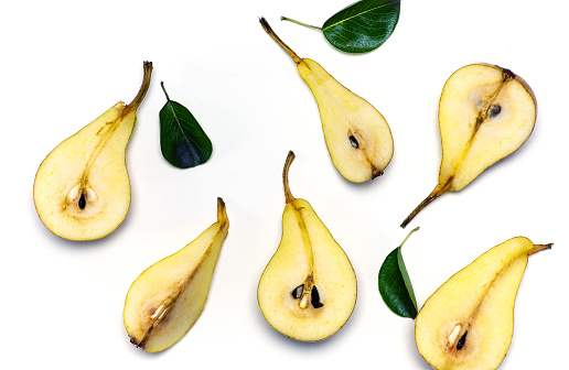 Fresh pears with leaves on white background. Fruit isolated flat lay