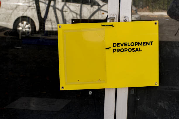 istock Development proposal yellow board on a dusty and dirty office building window in Sydney, NSW, Australia 1253215832