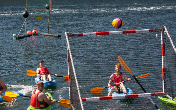 young people playing canoe polo in kayaks. - rowboat sport rowing team sports race imagens e fotografias de stock