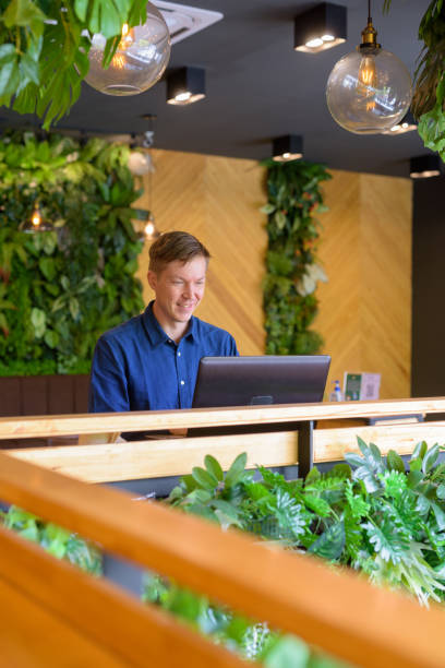 istock Happy young handsome businessman using laptop at the coffee shop 1253218314