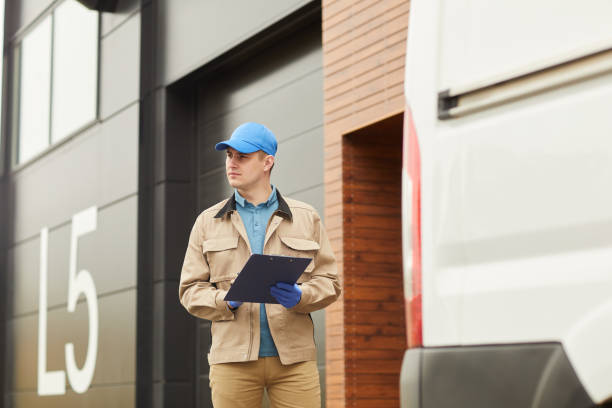 istock Delivery person working in warehouse 1253219527
