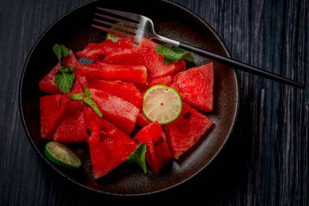 istock freshly cut watermelon salad kept in a black plate on a dark background 1253219908