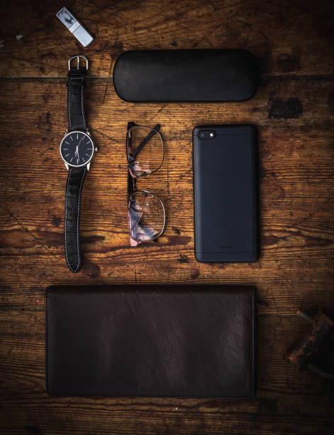 everyday carry flat lay photo wrist watch, glasses, cell phone, USB pen-drive and wallet on wooden vintage table wooden flash drive stock pictures, royalty-free photos & images