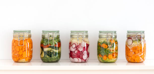 various fermented vegetables in mason jars on the kitchen shelf - golden beet fotos imagens e fotografias de stock