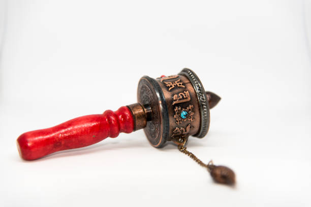 Prayer wheel Prayer wheel used by Buddhist monks isolated on a white background with use of selective focus. buddhist prayer wheel stock pictures, royalty-free photos & images