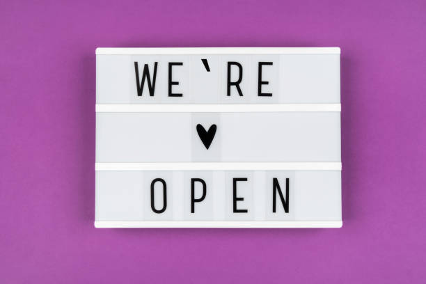 istock Text WE OPENED on a lightbox on a purple background. Information message for clients from the business owner 1253224622