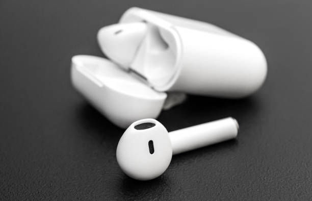 istock Bluetooth headphones with box on black background. 1253225289