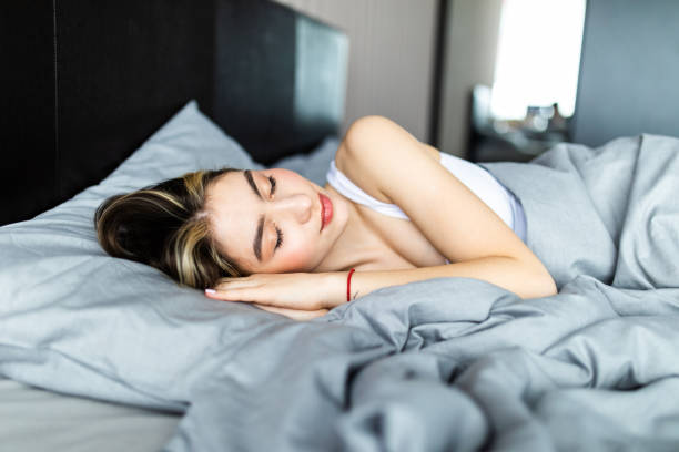 istock Beautiful young woman sleeping in a white bed. 1253225530