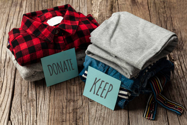 istock Stack of old clothes to discard (declutter) or keep. Recycle clothes, eco cotton 1253225580
