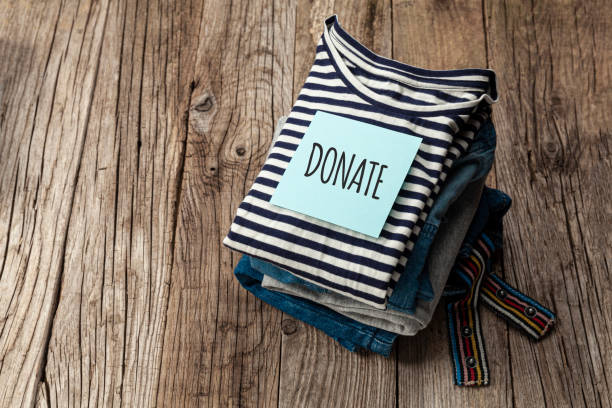 istock Stack of old clothes to discard (declutter) or donate. Recycling fabric cotton 1253225581