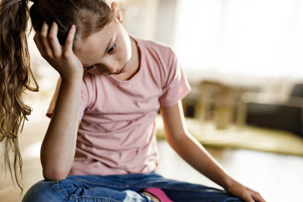 istock Small girl feeling depressed while being alone at home. 1253226266