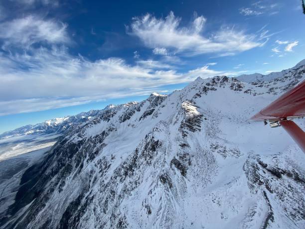 istock Snow capped mountains and flying 1253227948