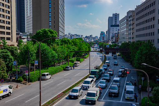 A city street at Yasukuni avenue in Tokyo daytime wide shot. Shinjuku district Tokyo Japan - 06.08.2020 : It is a center of the city in tokyo.