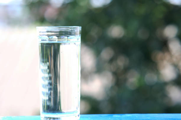 istock Glasses of water on counter background 1253229953