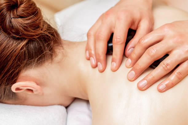 istock Stone massage on back of woman. 1253230341