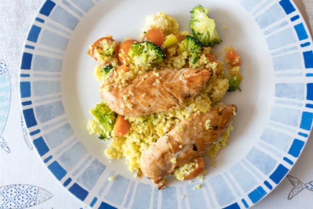 Couscous with vegetables and chicken stock photo