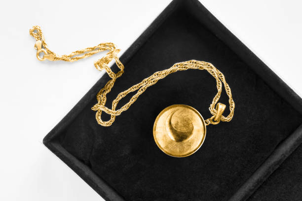 Necklace in a box Vintage gold locket pendant on gold chain in black jewel box closeup locket photos stock pictures, royalty-free photos & images