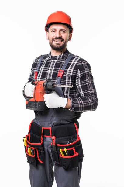 istock Portrait of a manual worker with helmet using a drill tool on white background 1253231641