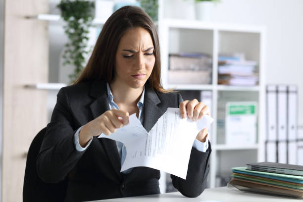 istock Angry executive breaking contract in the office at night 1253232481