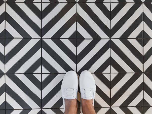 female legs on a black and white tile