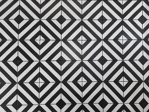 top view shabby black and white rhombus tiles on a coffee shop floor