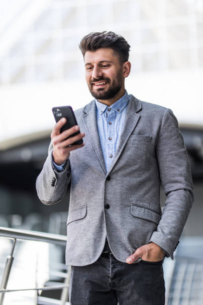 istock Young bearded businessman use and typing phone in office 1253233027