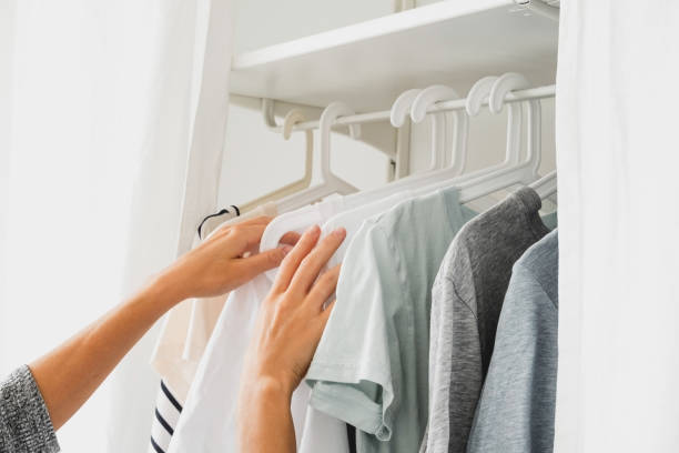 istock close up female hands and basic women's clothes on a hanger 1253233310