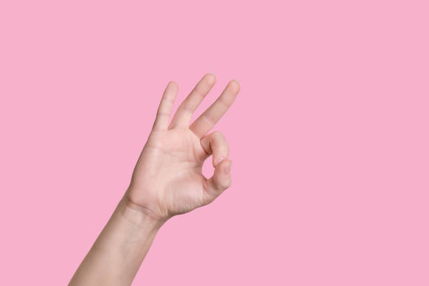 istock Close up hand showing ok gesture isolated 1253234015