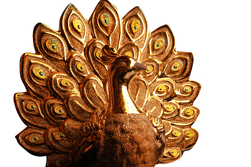 golden peacock statue isolated on white background.