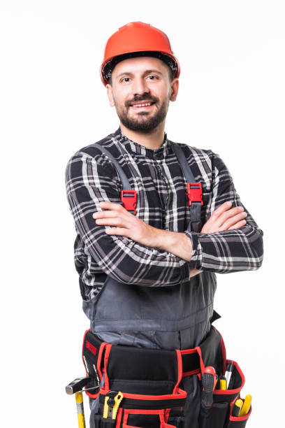 istock Handsome young handyman with arms crossed on white background 1253234513