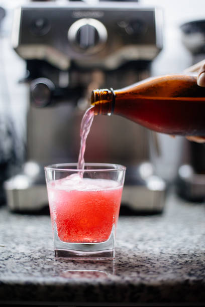 Pouring Kombucha with Pineapple and Hibiscus
