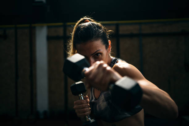 istock Woman working out with dumbbell 1253235963
