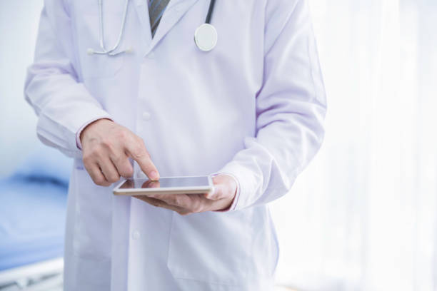 istock Doctor hold digital tablet with blank screen in hospital 1253236421